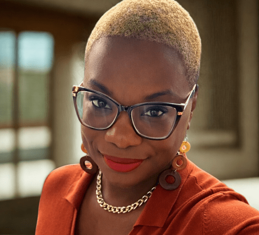 Dr. Treca Bourne in a Burnt Orange Dress