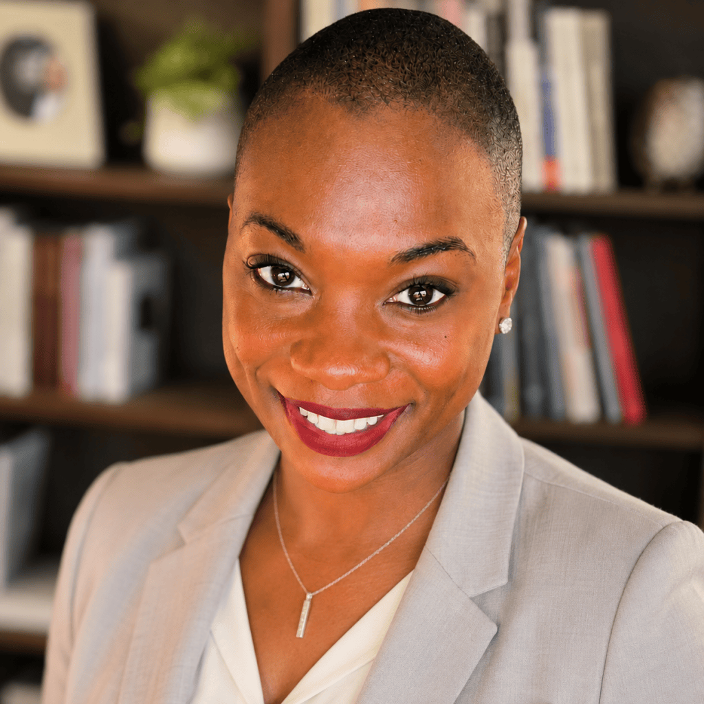 Black woman with a shaved head smiling